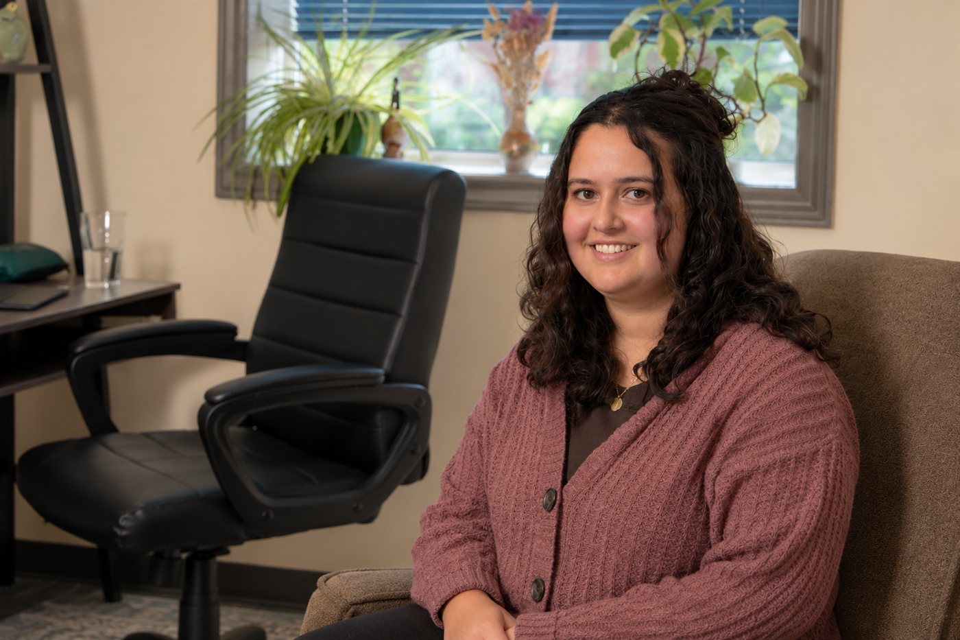 Cassie Holmes seated in the psychotherapy office at Shuqair Health & Wellness in Sarnia.